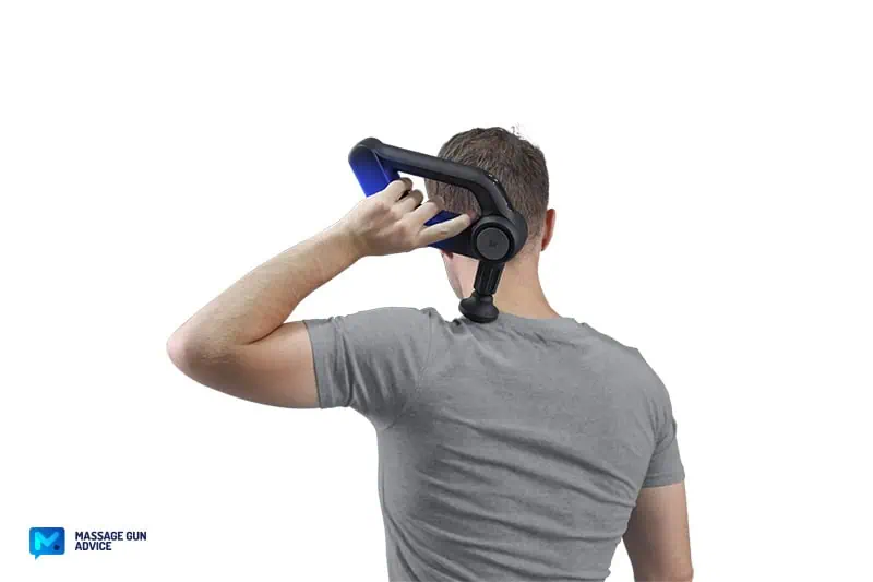 Bob and Brad D5 Pro Review: An Affordable Massage Gun For DOMs 16 a man holding bob and brad D5 Pro with the left hand while massaging his trapezius.