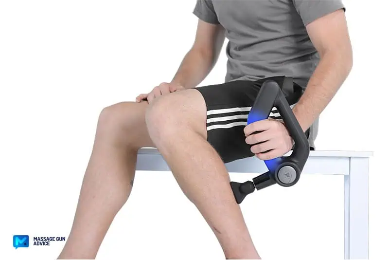 Bob and Brad D5 Pro Review: An Affordable Massage Gun For DOMs 17 a man holding bob and brad D5 Pro with the left hand while treating the his left calf.