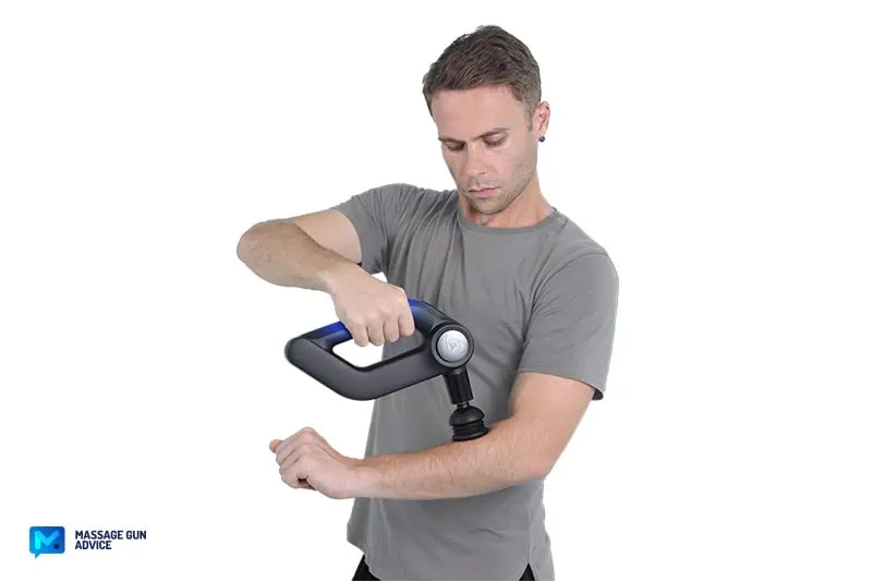 Bob and Brad D5 Pro Review: An Affordable Massage Gun For DOMs 15 a man holding bob and brad D5 Pro on the right hand while treating the left forearm