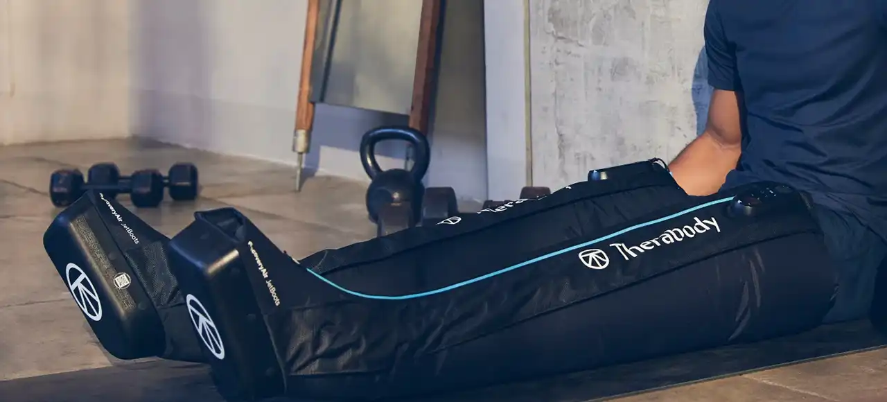 a man using Compression Therapy Boots Therabody