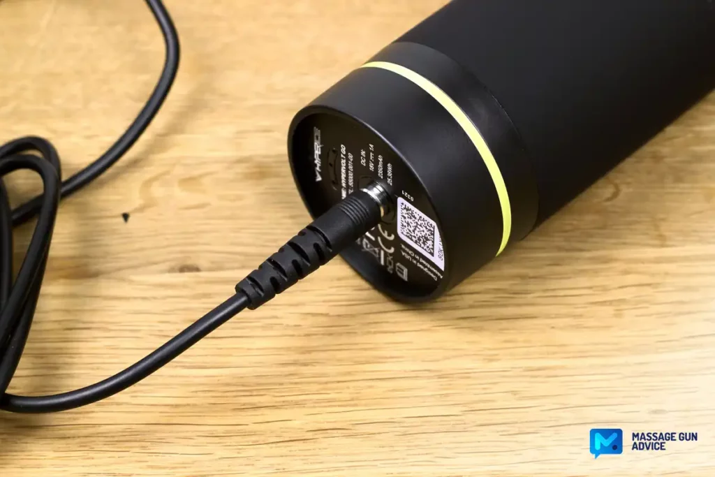 Ultimate Guide to Charging Your Massage Gun: Best Practices and Essential Tips 15 the handle of a black Hypervolt Go massage gun with a cable connect to Charging Port