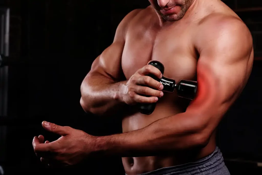 Bob And Brad Q2 Pro: Portable Hot & Cold Therapy 43 Topless Man Using bob and brad Q2 Pro Mini Massage Gun On His left Bicep
