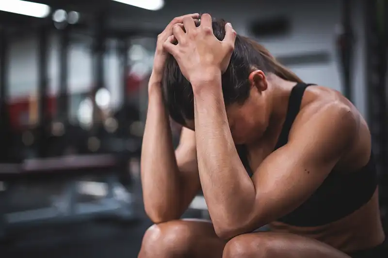 Complete Guide to Compression Therapy: What It Is and How It Benefits You 6 Woman At A Gym With Sore Muscles After Workout